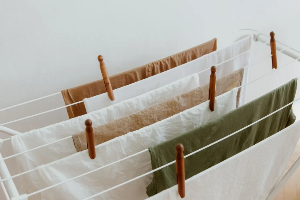 Neutral-colored textiles air-drying on an indoor rack