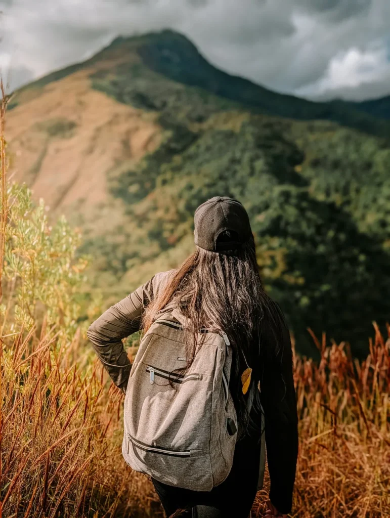 Backpacker wearing a long-sleeve top on a mountain trail.